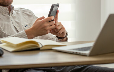 Close up, business man using mobile smart phone on wooden table. man using smartphone during working at office with digital tablet on table, social network, business success 