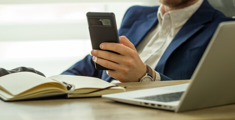 Close up, business man using mobile smart phone on wooden table. man using smartphone during working at office with digital tablet on table, social network, business success 
