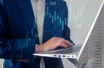 Business, finance and investment concept. man using laptop analyzing and calculating financial data with economic graph growth chart and numbers, Business strategy and planning. market research