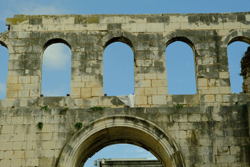 The archway is made of stone and has a white cloth draped over it