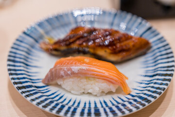 Japanese food style. Salmon sushi and Eel sushi served on a plate. Salmon sushi and Eel sushi roll maki.