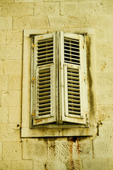 Fototapeta premium A window with two white slats and a white frame