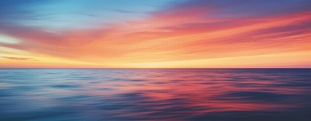 Obraz premium A breathtaking sunset over the ocean, with vibrant colors and rays of light piercing through fluffy clouds. 
