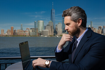 Business man using laptop pc outdoor in New York. American success Businessman . Remote freelance work. Online business in US. Business success. Management strategy. Outside business.