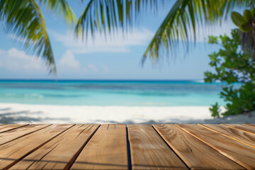 polished wooden table or platform with a smooth horizontal texture in the lower foreground, with a blurred tropical beach scene, including palm tree fronds on the upper left and right 