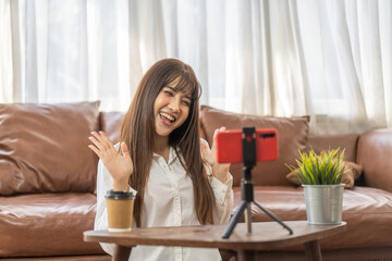Portrait of smiling beauty asian woman posing look at camera making live selfie, content, vlogger, blogger, live video streaming, broadcast, podcast, online influencer and creator on smartphone