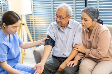 Fototapeta premium Portrait of smiling caring asian nurse service help support discussing and consulting taking care with senior elderly asian man and woman couple at home visit.senior retirement home care concept