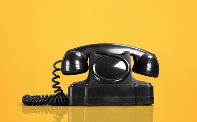 Vintage retro phone on color background
