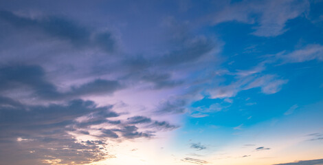 Dramatic Colorful Sunset Sky. Clouds with Sunrays. Cloudscape Sunset Background. Panorama Sky. Dramatic sky with clouds at sunset or sunrise. Sunset Sundown. Sky with colorful clouds.