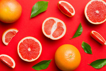 fresh Fruit grapefruit with Juicy grapefruit slices on colored background. Top view. Copy Space. creative summer concept. Half of citrus in minimal flat lay with copy space
