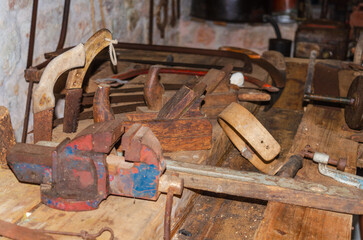 Old rusty tools lying on a wooden work bench