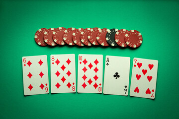 A very gambling game of poker with a winning combination of high cards. Playing cards and chips on...