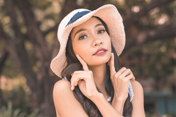 Young asian woman in hat posing in boho fashion