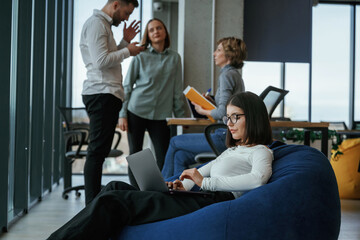 Obraz premium Employees are working together. People are in the office with bean bags chairs in it