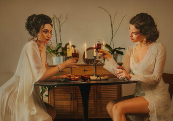 Two women Sexy girl beauty face lips sitting at the dinner table luxury light room. vintage nightie...