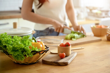Close-up photo of salad plate There is a picture in the background of a woman doing shortcuts for her health. and holding a tomato home cooking healthy lifestyle Eating healthy food Weight loss formul