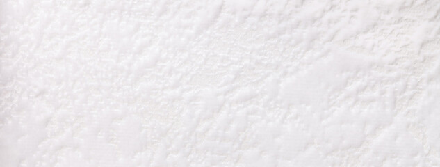 Texture of white velvet background from a soft upholstery textile material, macro. Abstract velour fabric