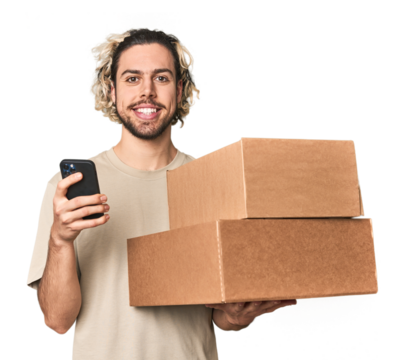 Young Caucasian man receiving packages, on phone in studio