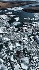 Fascinating green blue lagoon Jökulsarlon with ice blocks and great shapes coming from the neighbouring glacier in the mountains of Iceland 