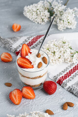 Ricotta dessert with fresh strawberries. Healthy breakfast of yogurt, strawberry and almonds