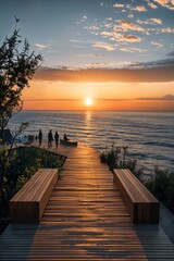 a wooden walkway leading to the ocean at sunset
