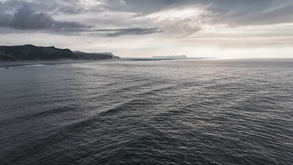 Cloudy sunrise over the sea with a slightly emerging sun