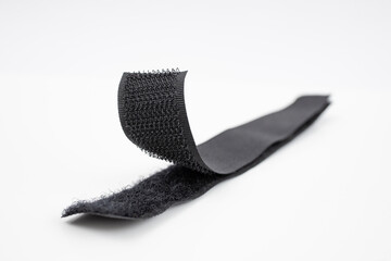 Fastener Velcro tape isolated on white, soft focus close up