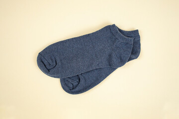 Gray stockings on beige background, flat lay close up