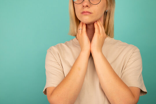 Female checking thyroid gland by herself. Thyroid disorder includes goiter, hyperthyroid, hypothyroid, tumor or cancer. Health care
