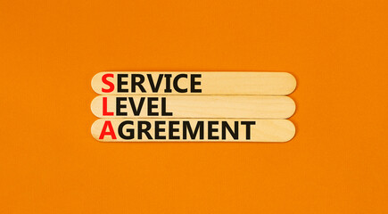 SLA service level agreement symbol. Concept words SLA service level agreement on beautiful wooden...