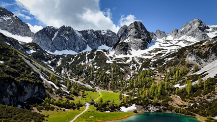 Incredibly beautiful green-blue mountain lake Seebensee in Austria, surrounded by trees and...