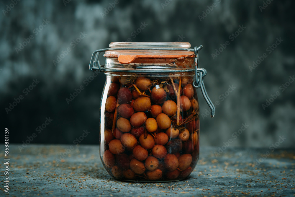 Poster marinated spanish arbequina olives in a mason jar