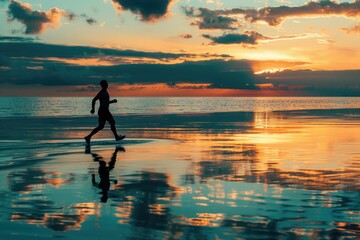 A man is running on the beach at sunset