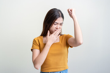 Bad smelling, deodorant asian young woman smell stink, breathing nose smelly on shirt dirty stinky laundry, disgusting from clothes after washed, smelly armpit underarm Medical health, skin body care.