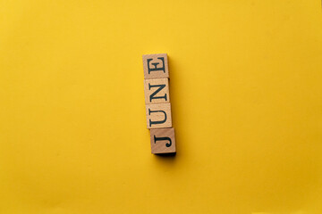 a yellow warm background without shadows wooden cubes with black letters laid out word stress