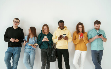 Obraz premium Standing against white background. Group of young people are together
