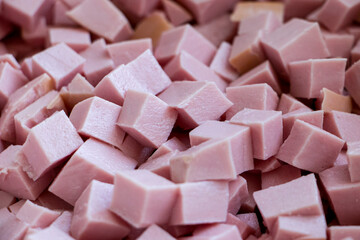 Sausage cube. Boiled sausage cut into cubes. View from above. Background.