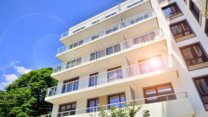 Obraz premium European residential architecture harmonizing with nature. Eco-friendly living in city with greens. Eco apartment building saving energy and fresh air concept. 