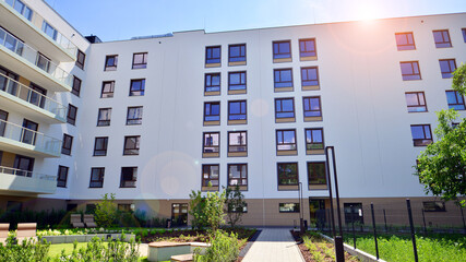 European residential architecture harmonizing with nature. Eco-friendly living in city with greens. Eco apartment building saving energy and fresh air concept. 