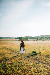 girl walking in the summer field
