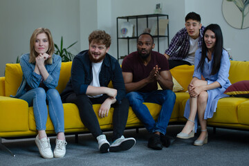 Obraz premium Multiethnic Enthusiastic Team Watching Presentation in Modern Office