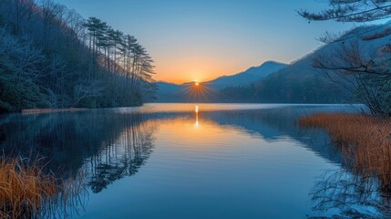 Fototapeta premium Serene Lake Reflecting First Light of Dawn: Surrounded by Silent Mountains