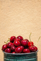 Fresh cherries on a peach background, a healthy eating concept, with space for text