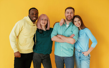 Fototapeta premium Front view. Group of friends are in the studio against background