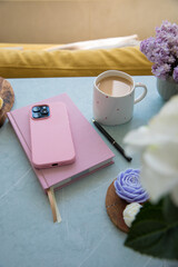 Pink diary and smartphone on the table