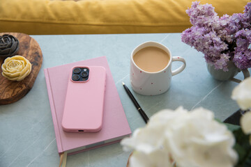 Pink diary and smartphone on the table
