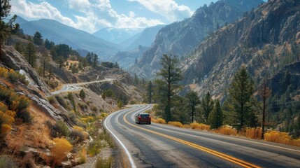 Fototapeta premium Scenic mountain road winding through an autumn landscape with vibrant foliage and a car driving along the curving path Outdoor adventure and travel concept