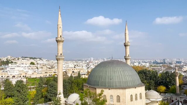 Sanliurfa city in Turkey, mosque and brids flying in blue sky