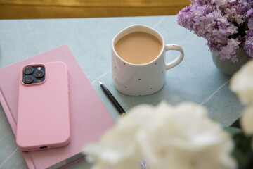 Pink diary and smartphone on the table