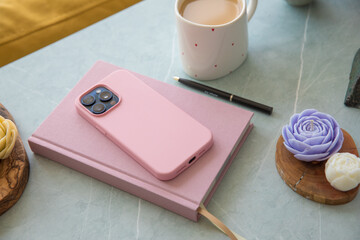 Pink diary and smartphone on the table